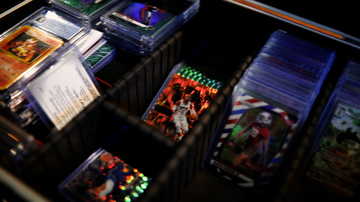 Collection of trading cards in a display case with various designs and colors.