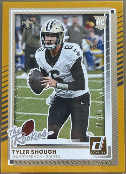 Football trading card of Tyler Shough with a gold border and player image on a field.